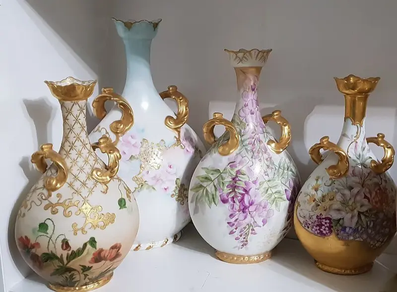 Antique Limoges porcelain vases with hand-painted floral motifs and gold gilding